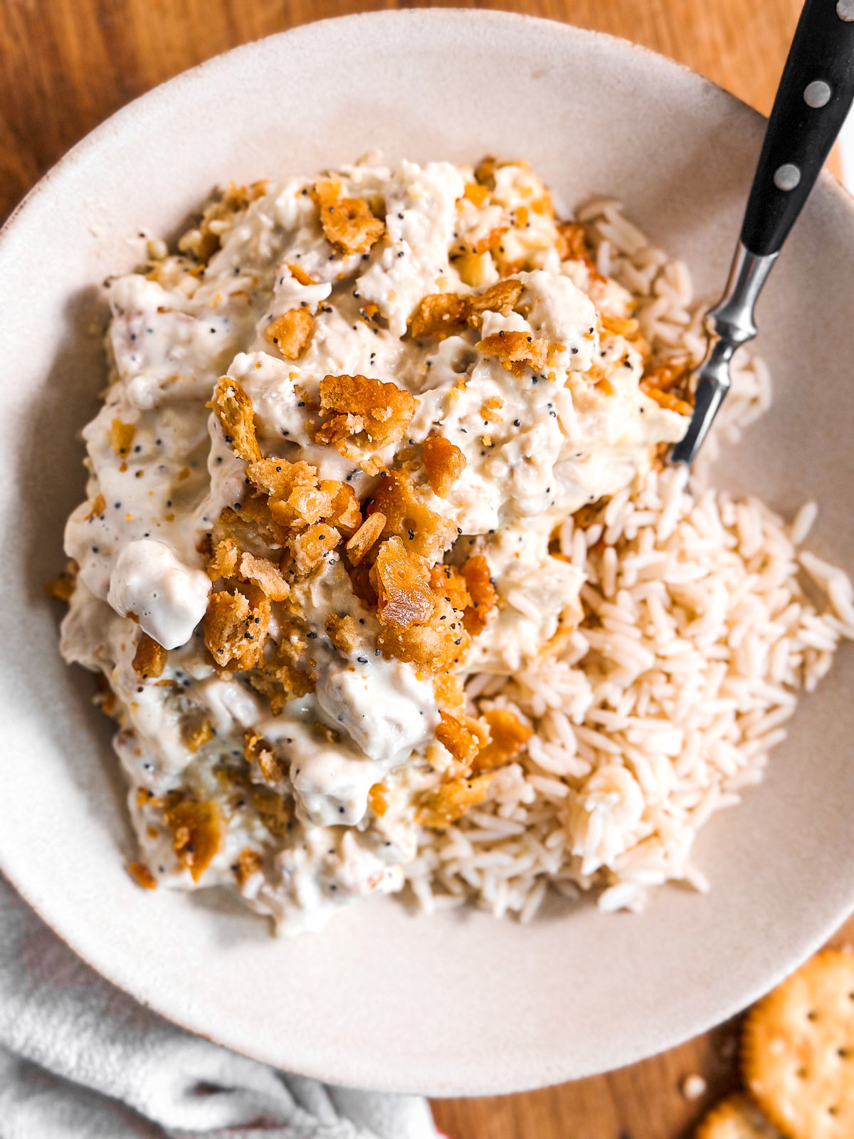 overhead view of poppy seed chicken casserole with rice in white bowl