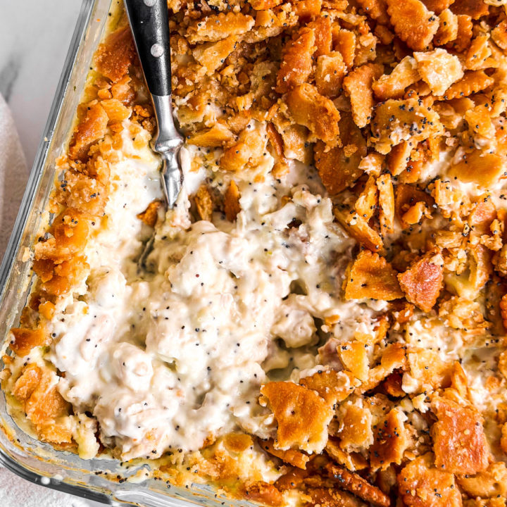 overhead close up photo of poppy seed chicken casserole in glass dish