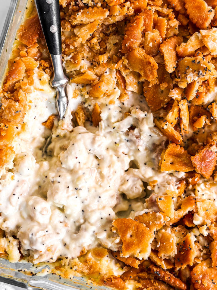 overhead close up photo of poppy seed chicken casserole in glass dish