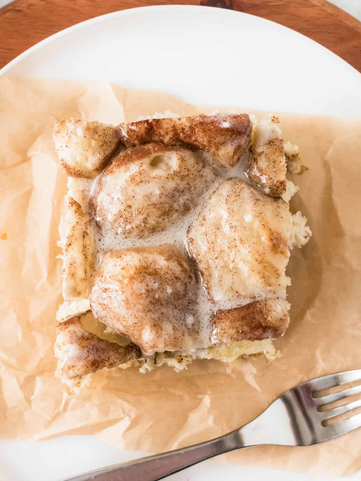 overhead close up view of cinnamon roll casserole on plate