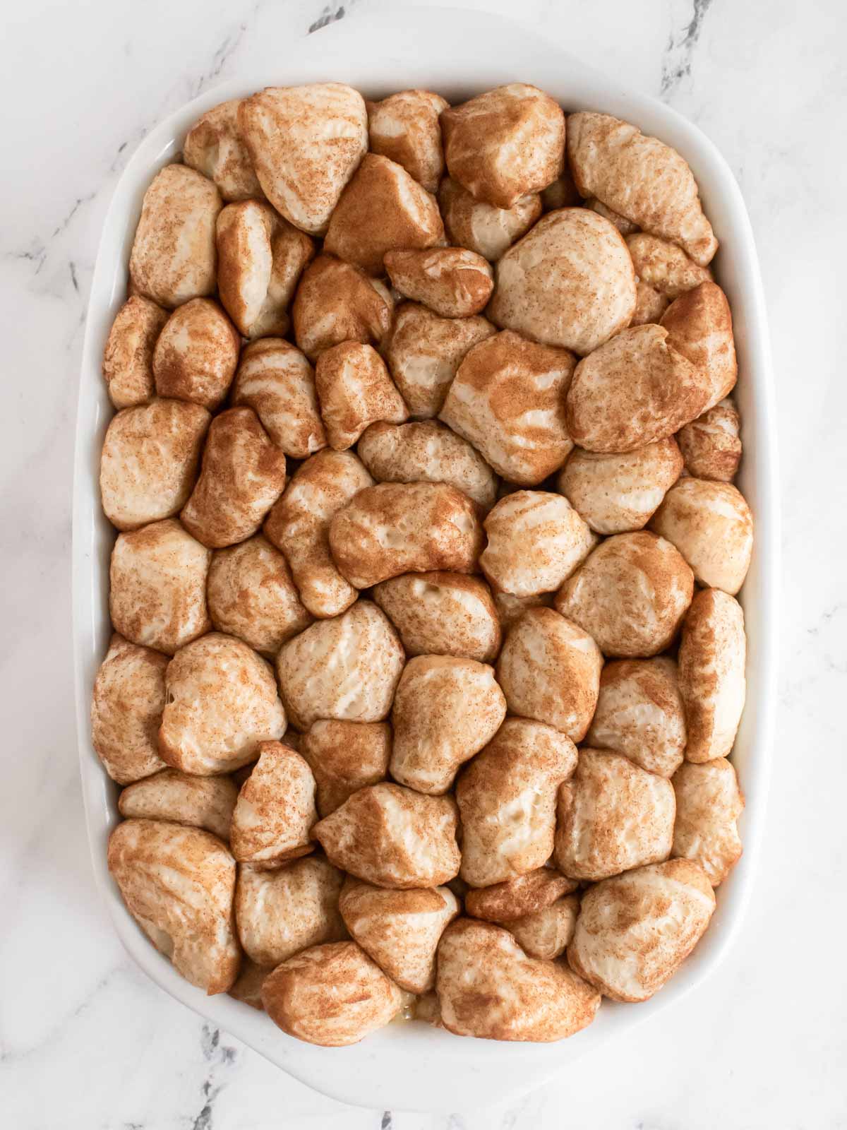 overhead view of cinnamon roll casserole after rising