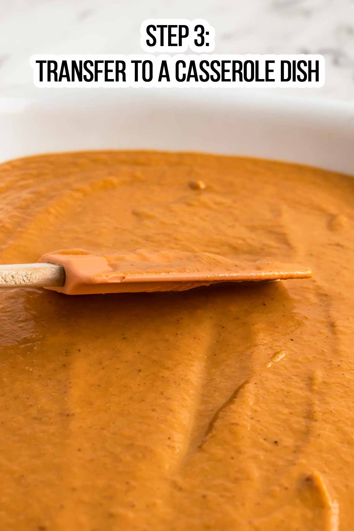 close up photo of spatula spreading pumpkin filling in white dish