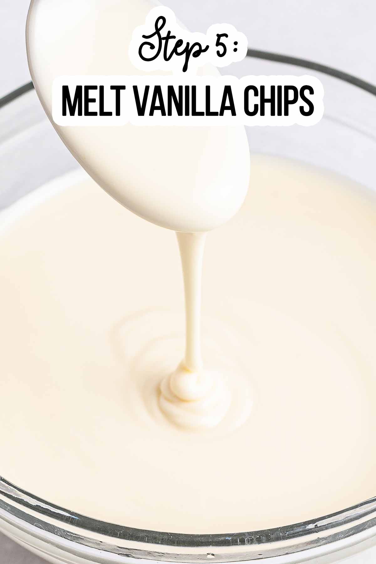 frontal close up of melted vanilla chips dipping from spoon